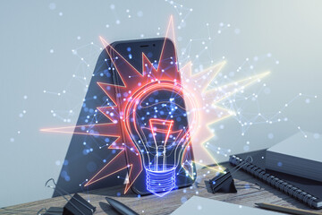Aufkleber - Abstract holographic light bulb glowing over a smartphone on a desk.