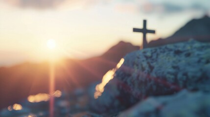 Wall Mural - a cross atop a mountain summit captures the beauty of sunset, with golden light illuminating the roc