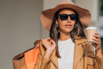 modern latin girl with sunglasses and shopping hat