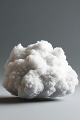 Poster - A white cloud sits on a gray surface, perfect for backgrounds and compositions
