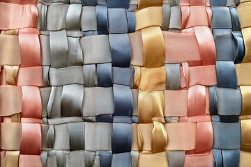Aufkleber - Artistic display of mixed color ribbons woven together, forming an abstract texture that represents complexity and unity through its blending of diverse elements.