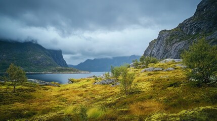Aufkleber - A serene landscape featuring a grassy hill overlooking a calm lake and distant mountains