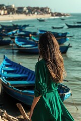 Poster - A woman stands in front of boats wearing a green dress, great for use as a background or decorative element