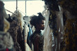 © ADDICTIVE STOCK CORE - Young Black woman browsing through elegant dresses. Generative AI image