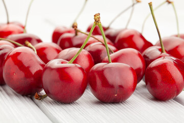 Wall Mural - red cherry on white wood background