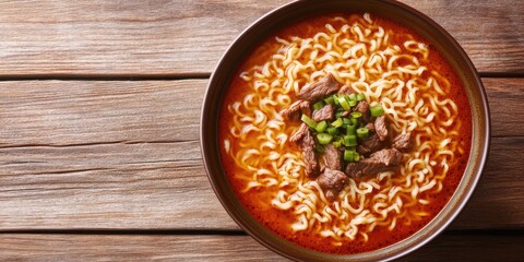 Poster - Closeup of beef noodle ramen in tomato sauce broth garnished with green onions in a brown bowl on a textured wooden table with warm tones