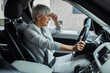 © Davor - Senior businesswoman stressed inside a car