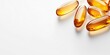 © Lala - Five amber fish oil capsules arranged diagonally on a bright white background, creating ample space for text and branding elements.