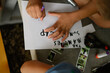 © Dj - Close up of a child creating their summer camp journal. Teaching children empathy and responsibility at a Nature Preschool in Detroit, MI