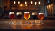 © DDOO - A selection of five different craft beers in elegant glasses, showcasing various colors and foamy tops, arranged on a wooden bar counter.
