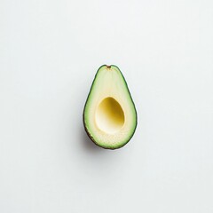 Poster - Sliced green avocado displaying smooth flesh and vibrant skin on a light surface