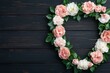 © Arfa_Media - Heart-shaped wreath forming a frame with pink and white flowers on rustic wooden background