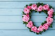 © Arfa_Media - Heart-shaped wreath with pink peonies forming a heart on rustic wooden background