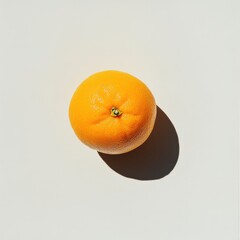 Aufkleber - Ripe orange with smooth peel resting on a neutral surface casting a soft shadow in natural light