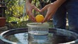 © vadosloginov - Creative physics experiment demonstrating concepts of buoyancy and density with a lemon in water during a school outdoor session