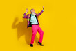© deagreez - Full body portrait of positive grandfather vibrant designer outfit dance empty space isolated on yellow color background