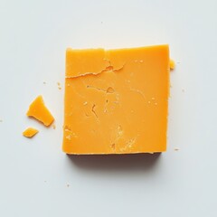 Poster - Sharp cheddar cheese slice on clean surface with a piece broken off