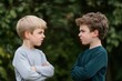 © Evon J - Two young caucasian boys facing off outdoors with determined expressions International Stand Up to Bullying Day