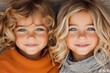 © Vertigo Images - Adorable twin girls with long blonde and light brown curly hair, striking blue eyes, and sweet smiles.  A heartwarming sibling portrait.