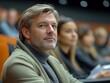 © Darni - Attentive man in audience at conference.