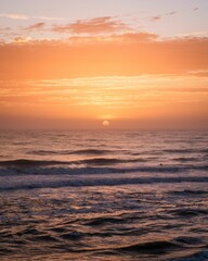 Wall Mural - Sunrise over waves in the Atlantic Ocean in St. Augustine Beach, Florida