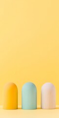 Poster - Minimalist Display of Colorful Wooden Figures on Yellow Background