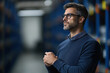 © Mselected - Thoughtful man in glasses contemplating in a modern warehouse setting