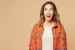 © ViDi Studio - Young shocked surprised impressed excited happy woman she wear orange shirt casual clothes look aside on area mockup isolated on plain pastel light beige background studio portrait. Lifestyle concept.