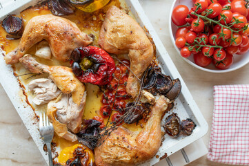 Wall Mural - Roasted chicken legs with oven vegetables on a baking tray fresh and homemade cooked