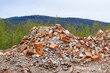 © Jan Haz - Construction waste dump with a pile of broken bricks and a pile of masonry.
