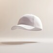 © Selsi - Floating white baseball cap on beige background.