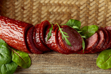 Wall Mural - Sliced salami on a old wooden board.