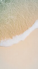 Poster - Soft waves gently rolling with white foam onto the sandy beach shore, creating a serene and tranquil atmosphere perfect for relaxation and enjoying the beauty of nature
