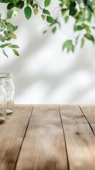 Aufkleber - Empty glass jars resting on a light brown wooden table, surrounded by hanging green plant branches, create a warm and inviting atmosphere in a natural kitchen setting