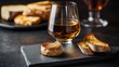 © designer - Delightful pairing of glass of cognac with foie gras pâté and toasted bread on a slate serving board during an evening gathering