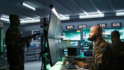 Poster - Military dispatcher using headphones microphone, offering info to infantry units fighting on front lines. Army expert providing intel for troops, coordinating mission activities, camera B