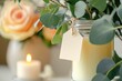 © Studium L&M - Elegant wedding favor tag mockup with candle and floral backdrop, perfect for romantic event branding.