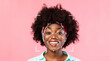 © Prostock-studio - A person with a joyful expression stands against a pink background. Facial identification technology analyzes their features while they smile, showcasing advanced recognition capabilities.