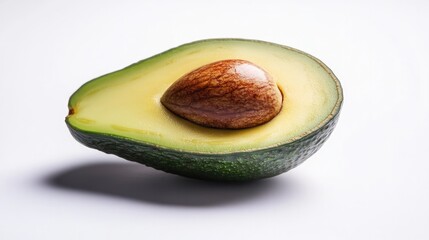 Poster - single avocado half placed on clean white backdrop with its seed intact and vibrant green flesh leaving generous copy