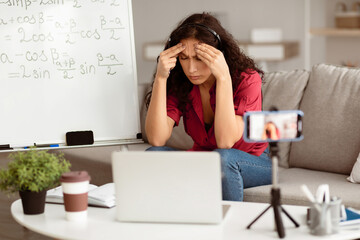 Aufkleber - Fatigue From Work. Tired young woman in headset feeling headache or stress, touching and massaging her forehead and temples, having video lesson with students, sitting at desk recording video