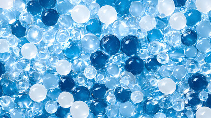 Fototapete - A vibrant assortment of translucent beads in varying shades of blue and white, creating a visually striking pattern against a light background