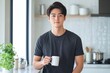 © andyaziz6 - Man Holds Coffee Mug in Modern Kitchen, Enjoying Serene Morning Calmly