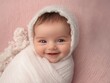 © Riz - Adorable Smiling Baby Girl Wrapped in White Fabric on Pink Background
