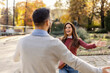 © Dusan Petkovic - Happy young couple in love running towards each other in city park.