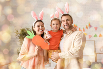 Wall Mural - Happy family in bunny ears holding Easter decor at home