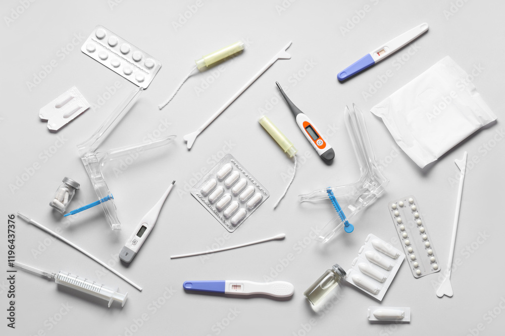 Set of gynecological supplies on grey background