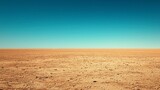 Vast, flat desert landscape under a clear blue sky.