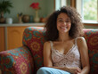 © Николай Срибяник - Relaxed woman with curly hair smiling while reclining on vibrant patterned couch