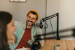 © La Famiglia - Teamwork on display: Podcast hosts chatting animatedly in a brightly lit recording room