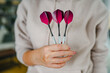 close up of woman handhold a pink dart ready for playing with them